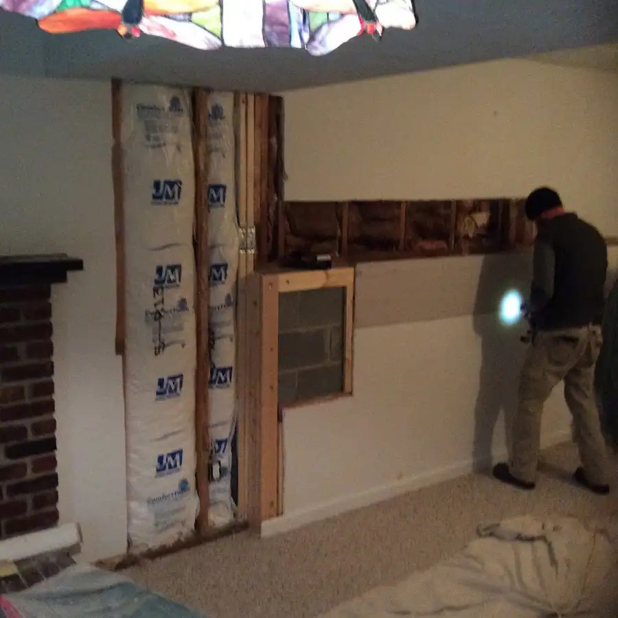 Restoration technician inspecting water damage in Tyrone